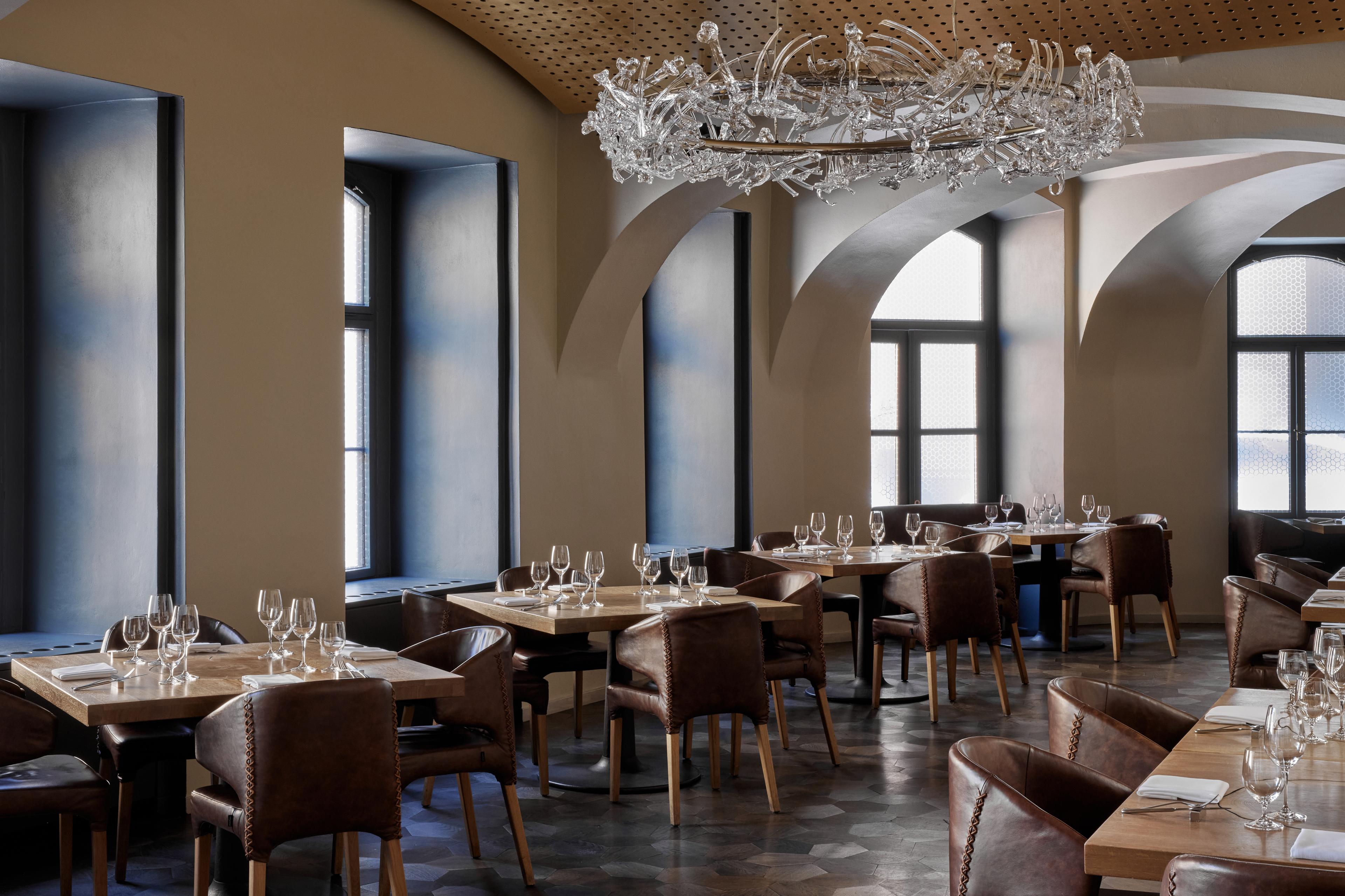 dining room with multiple windows and a modern chandelier above the tables