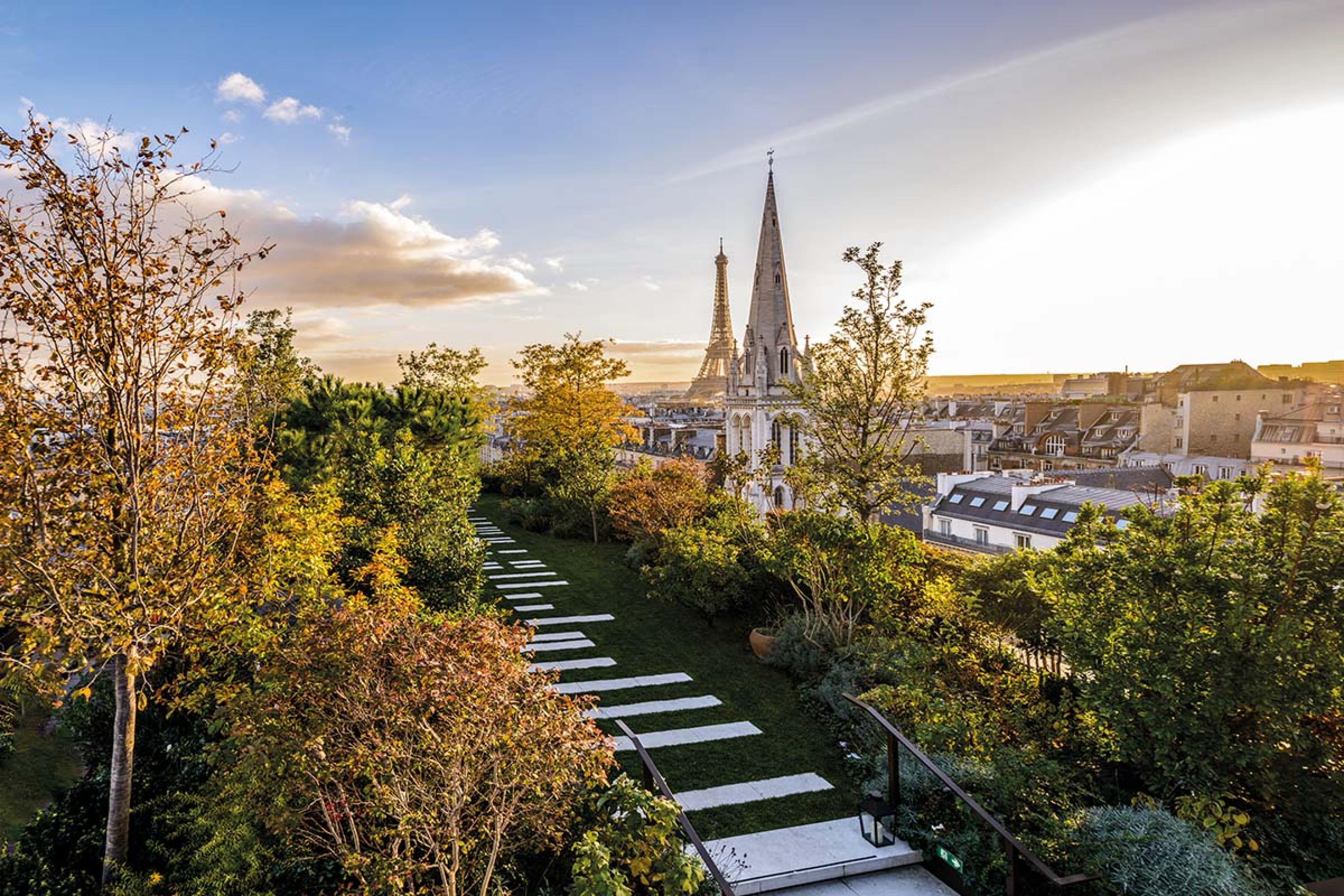 rooftop garden with a stone path overlooking the Eiffel Tower